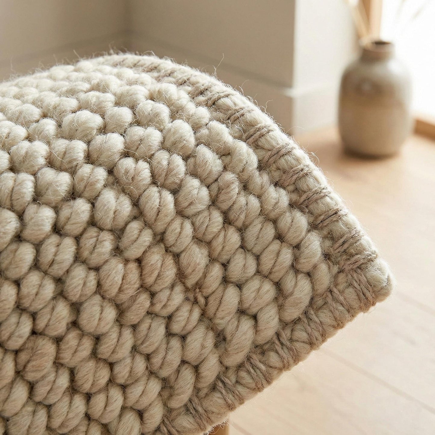 Chunky knit neutral rug with thick textured natural fibers for cozy Scandinavian homes