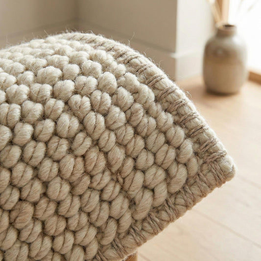 Chunky knit neutral rug with thick textured natural fibers for cozy Scandinavian homes