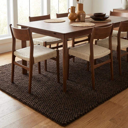 Chunky knit rug in dark brown with thick braided roving texture for cozy modern spaces