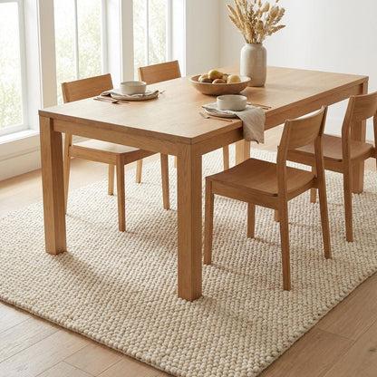 Chunky knit wool rug with thick cream looped texture, soft and cozy floor accent for neutral modern interiors