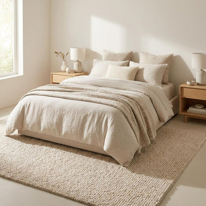 Handwoven chunky knit wool rug in ivory with thick soft loops, perfect for cozy minimalist living rooms