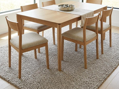 Handmade chunky knit wool rug in neutral beige with pebble texture, thick and cozy for modern minimalist interiors