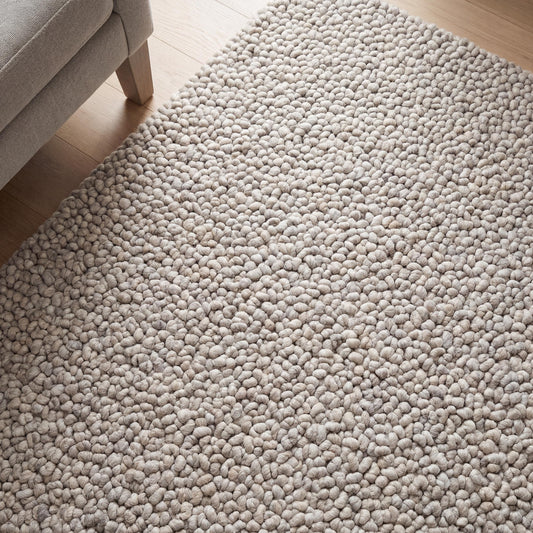 Chunky knit wool rug in neutral beige with pebble texture, handmade thick cozy area rug for modern minimalist decor