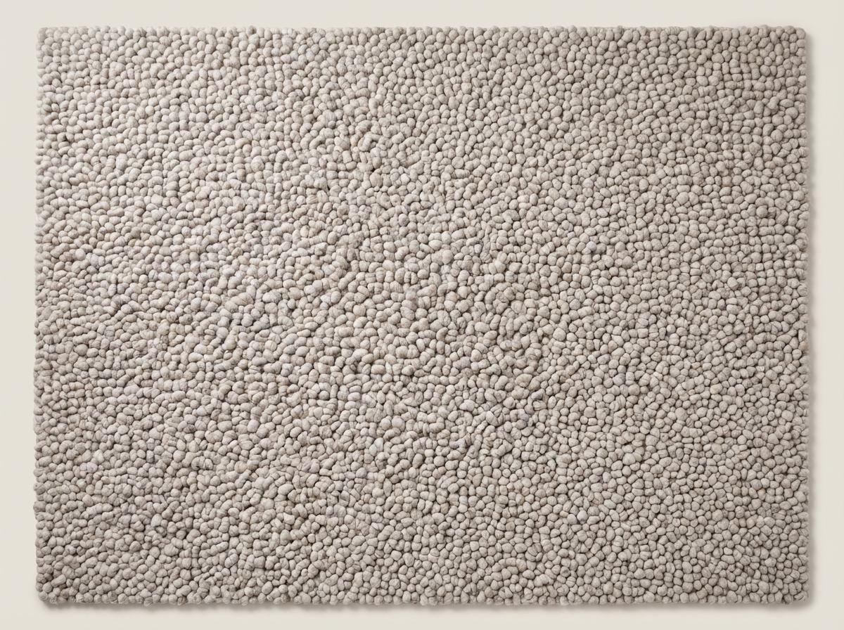 Handmade chunky knit wool rug with thick neutral beige pebble texture, cozy modern minimalist area rug