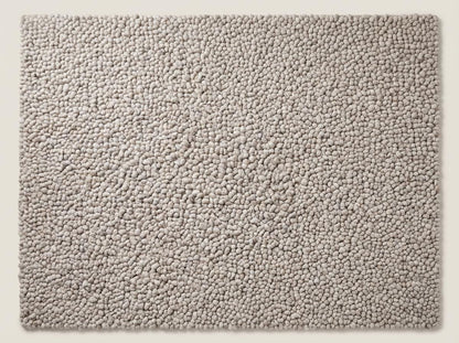 Handmade chunky knit wool rug with thick neutral beige pebble texture, cozy modern minimalist area rug