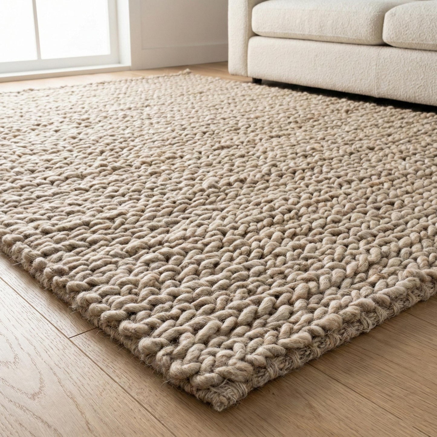 Chunky knit wool rug with thick oversized loops, plush texture, and neutral Scandinavian design for cozy home decor