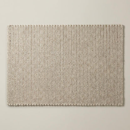 Chunky knit wool rug in neutral cream color with thick plush loops for cozy living room décor