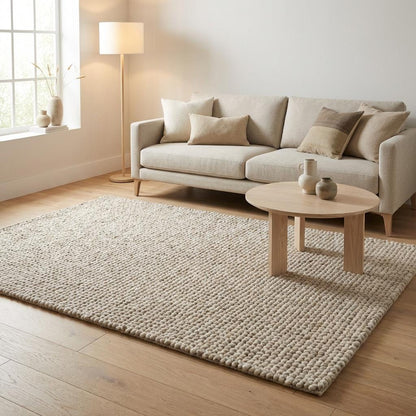 Chunky knit wool rug with thick plush loops in a neutral tone for cozy modern home décor and soft textured luxury floor covering