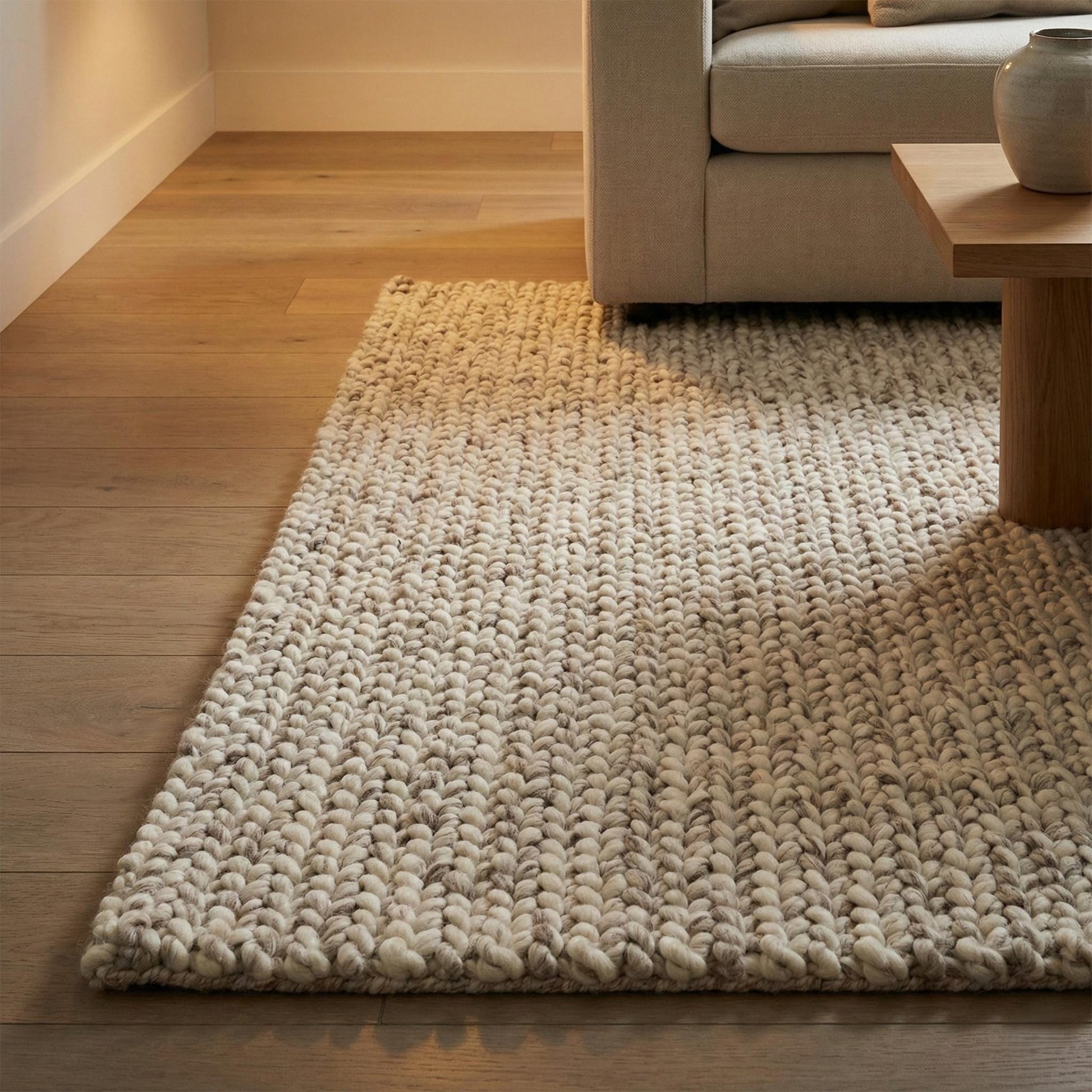 Chunky knit wool rug with thick plush loops in neutral tones for cozy modern home décor