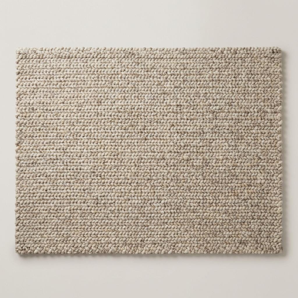 Chunky knit wool rug with thick neutral wool loops in cozy modern living room setting