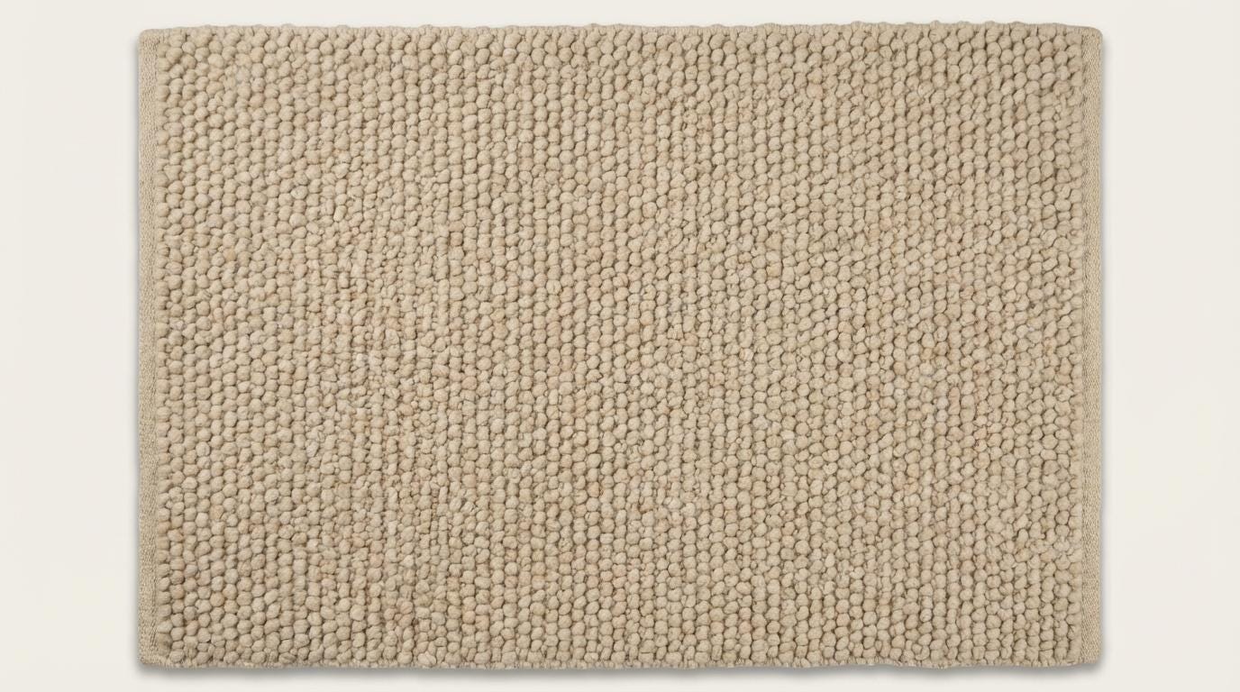 Chunky knit wool rug in cream beige with thick hand-knit texture and plush wool strands