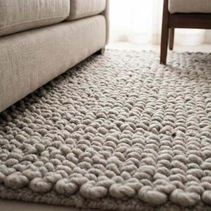 Chunky loop rug in neutral ivory with thick, textured, plush surface for cozy modern living rooms