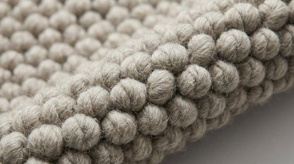 Chunky loop rug in neutral ivory with thick, plush texture for cozy modern living rooms