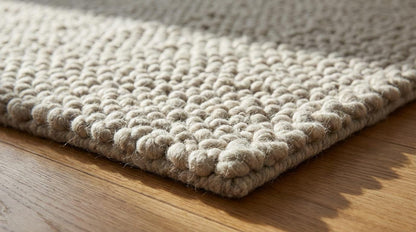 Chunky loop rug in neutral ivory with thick, plush texture for cozy modern living rooms