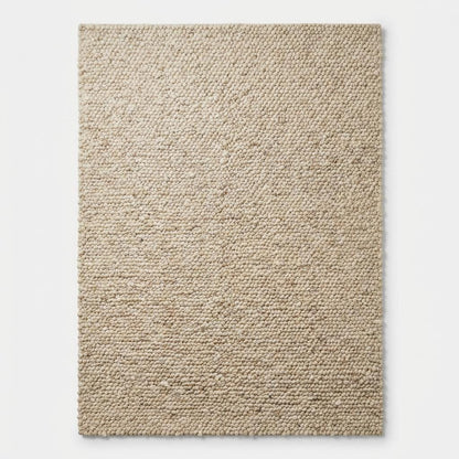 Chunky loop textured cream area rug with plush, nubby surface and modern organic design