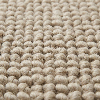 Close-up of oversized pebble loop texture in neutral beige rug