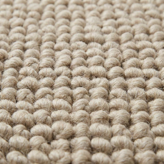 Close-up of oversized pebble loop texture in neutral beige rug