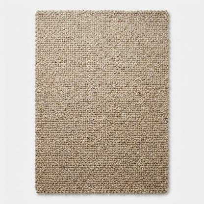 Top-down view of solid chunky textured rectangular beige floor rug