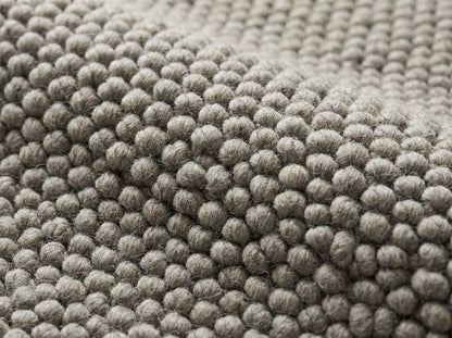 Chunky loop textured neutral area rug with thick yarn in minimalist Scandinavian style for cozy living room