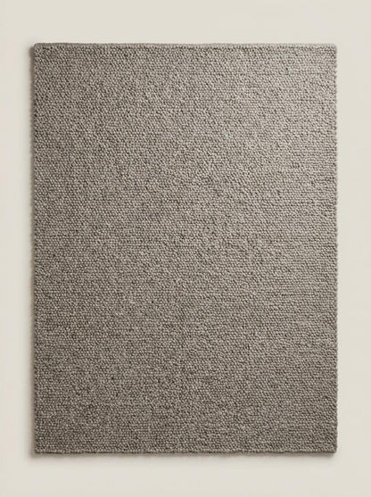 Chunky loop textured neutral rug with thick yarn and cozy Scandinavian style in minimalist living room