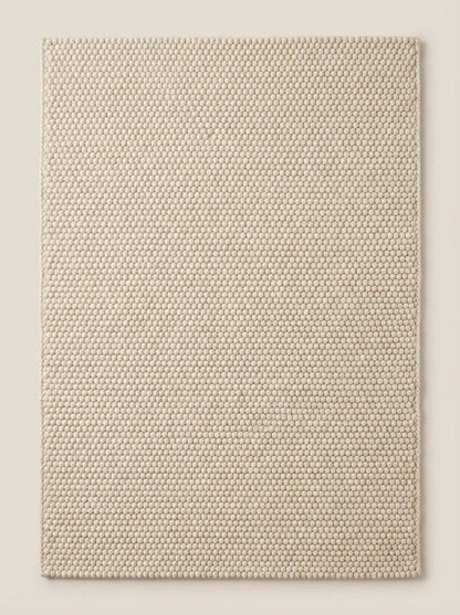 Top surface texture of plush loop rug with dimensional woven rows