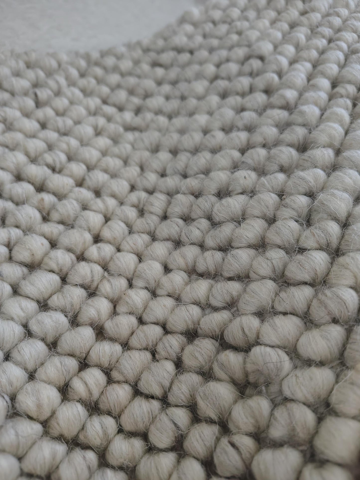 Chunky looped ivory rug with thick textured loops and neutral minimalist design for cozy, warm flooring accents