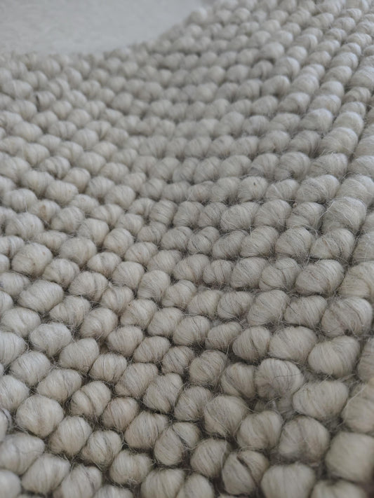 Chunky looped ivory rug with thick textured loops and neutral minimalist design for cozy, warm flooring accents