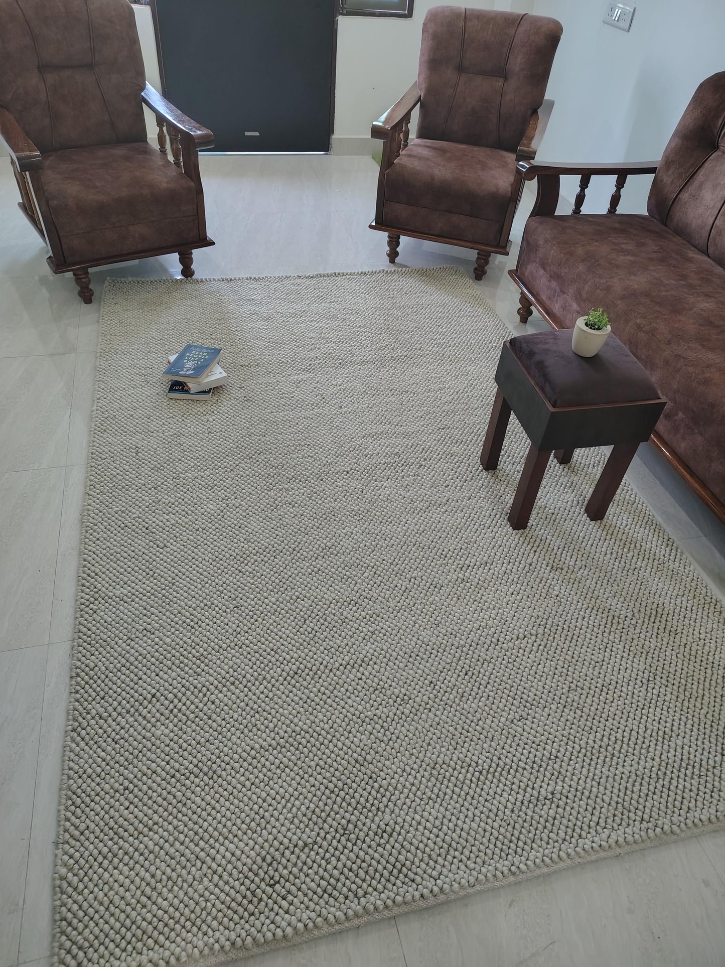 Top-down view of solid neutral rug with oversized yarn loops