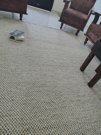 Modern minimalist rug in soft ivory with heavy dimensional texture