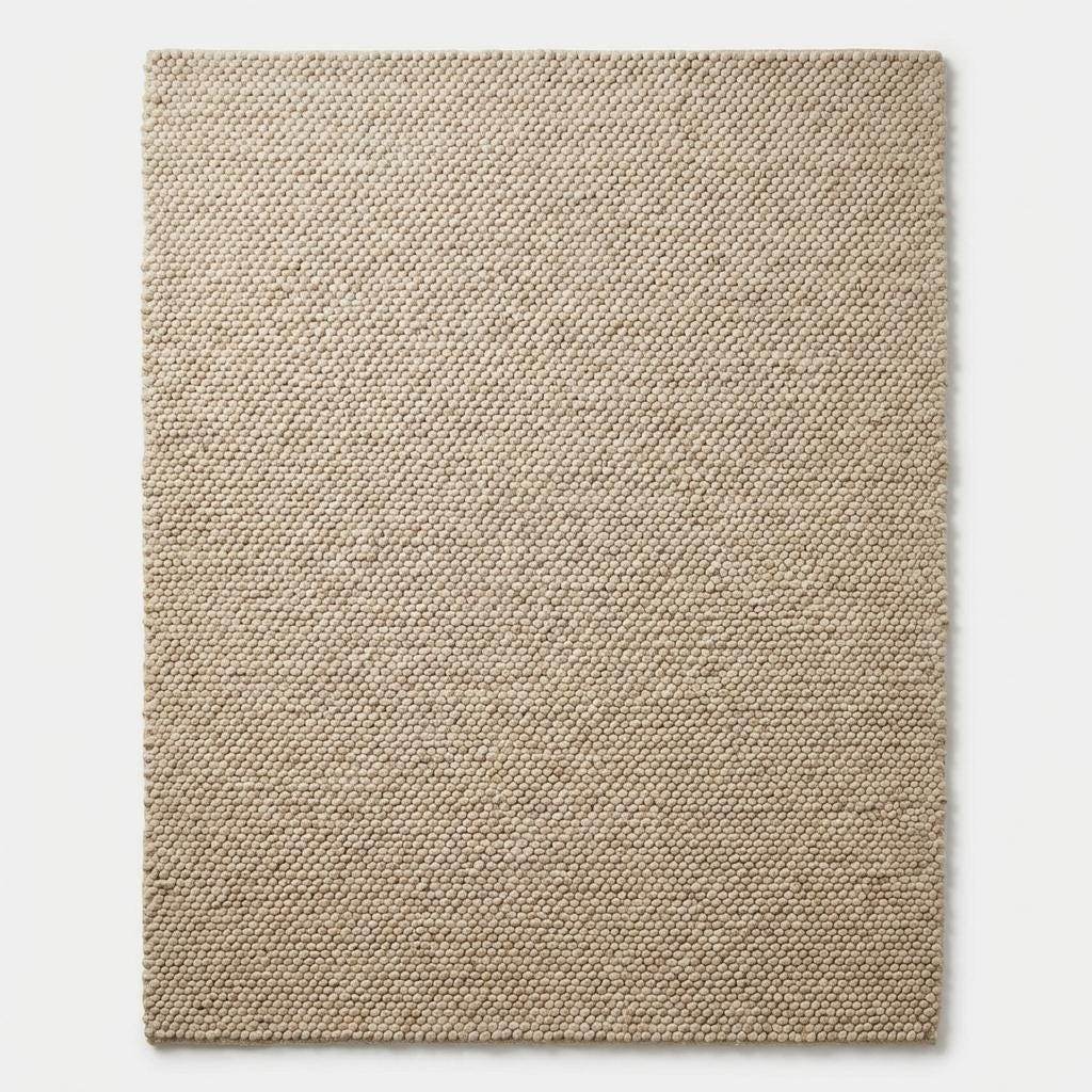 Top-down view of chunky cream area rug with structured edges
