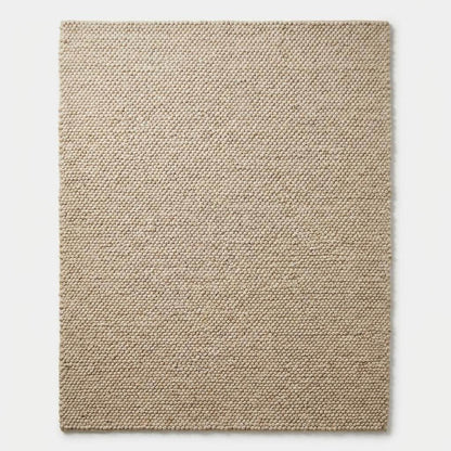 Top-down view of chunky cream area rug with structured edges
