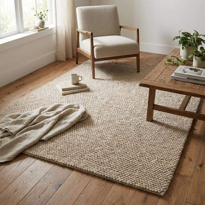 Soft neutral rug styled in serene bedroom corner with organic décor