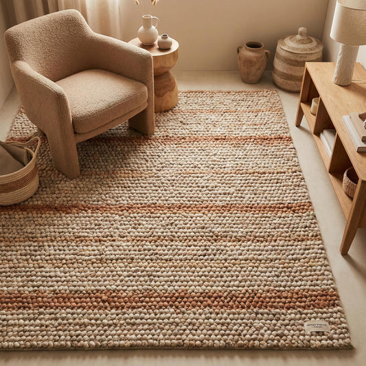 Chunky wool area rug with neutral warm stripes and thick textured loops in cozy modern living room
