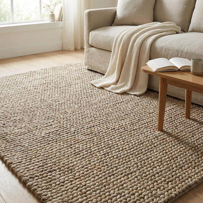 Chunky wool area rug with thick braided texture in neutral beige for cozy living rooms