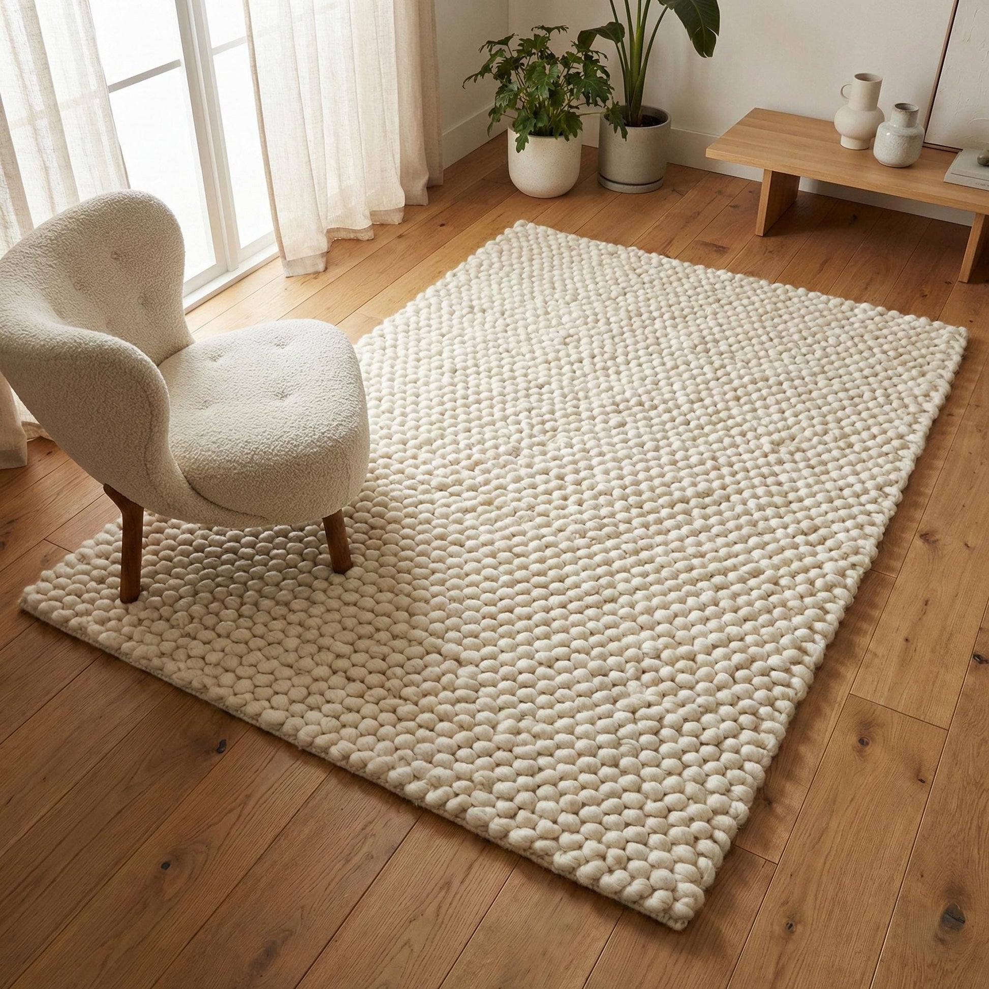 Chunky wool ivory area rug with thick textured loops in Scandinavian neutral living room setting