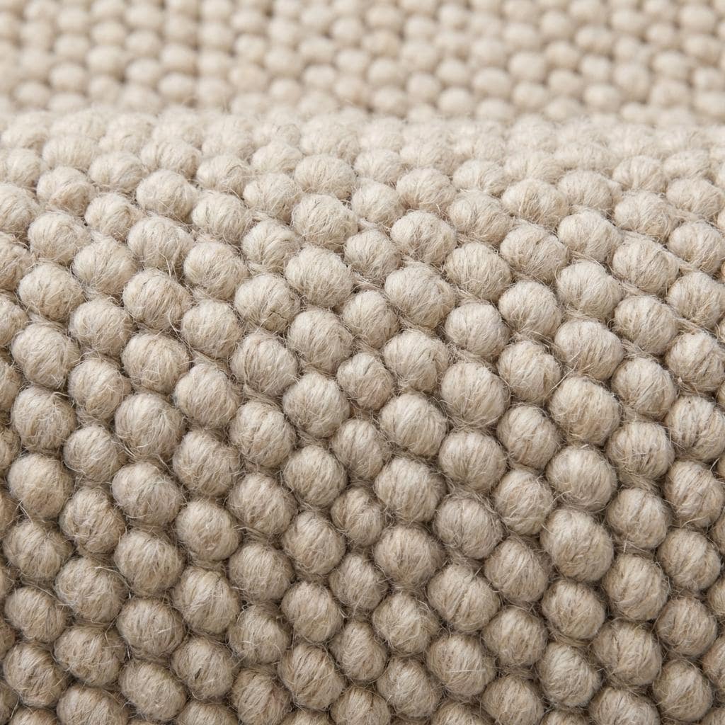 Close view of oversized loop texture rug showing thick natural yarn structure