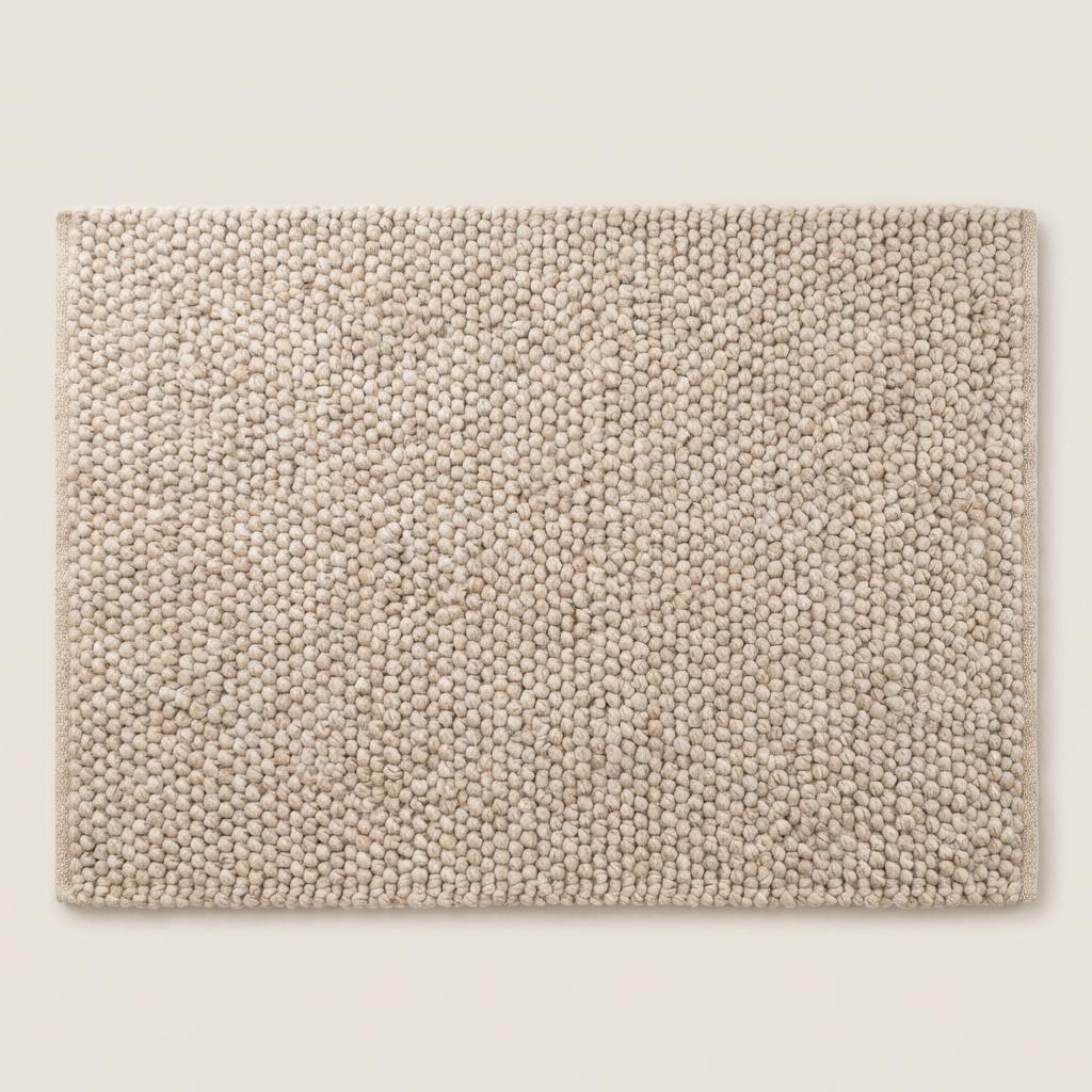 Top view of neutral chunky knit style rug with sculptural braided texture