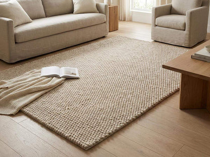 Cozy contemporary bedroom-style setting with soft neutral textured area rug