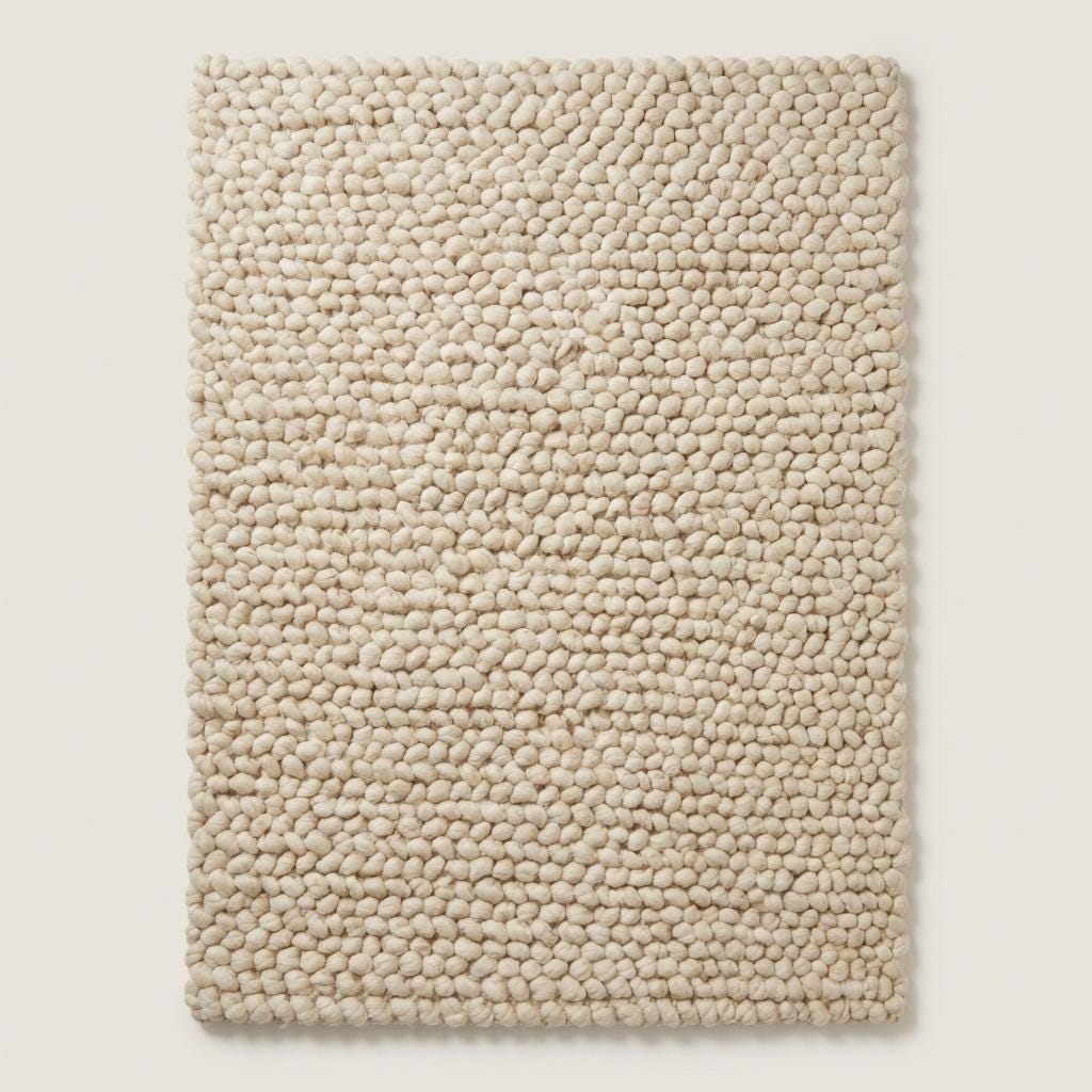 Cream chunky wool loop rug with thick oversized yarn loops and textured cozy design