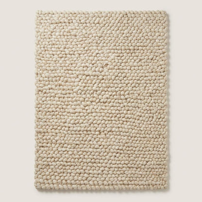Cream chunky wool loop rug with thick oversized yarn loops and textured cozy design