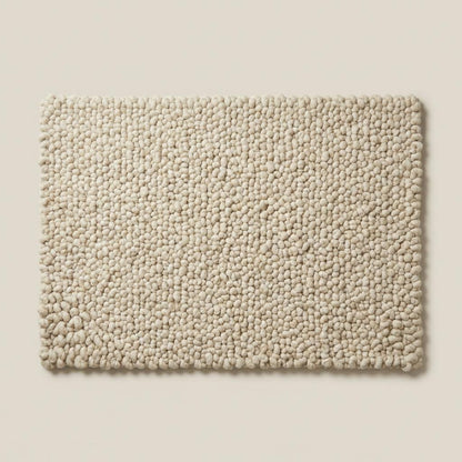 Handcrafted chunky wool loop rug in cream with thick textured loops for cozy, plush neutral area decor