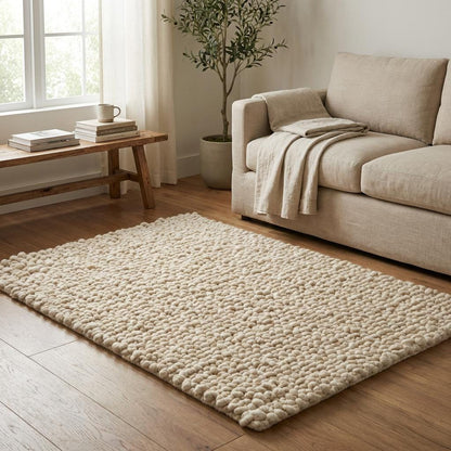 Handcrafted chunky wool loop rug in cream with thick textured loops for cozy neutral hygge decor