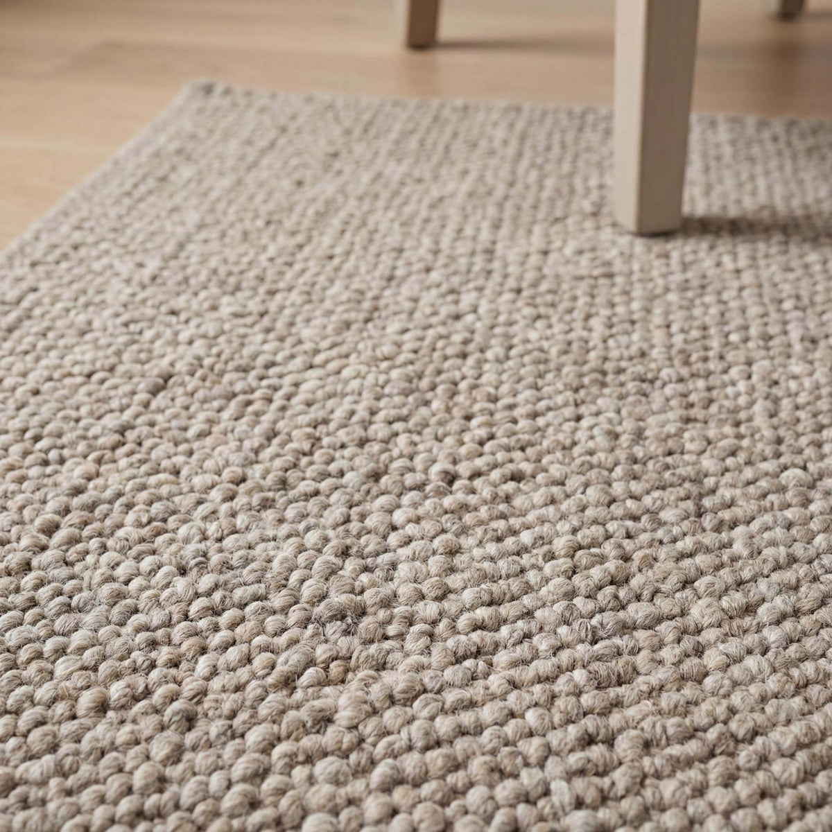 Chunky wool loop rug in neutral beige with thick textured weave for cozy Scandinavian home decor