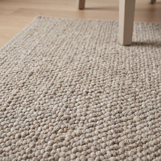 Chunky wool loop rug in neutral beige with thick textured weave for cozy Scandinavian home decor