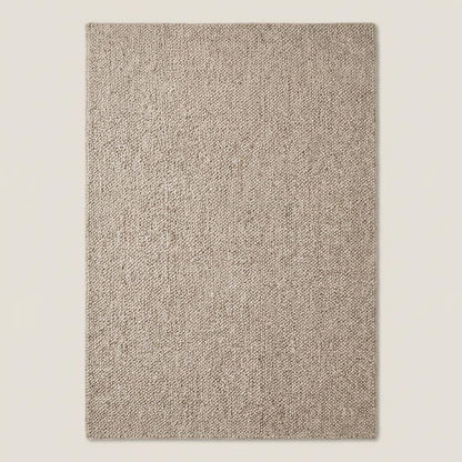 Handwoven chunky wool loop rug in neutral beige with thick texture for cozy minimalist Scandinavian home decor