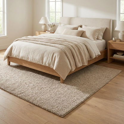 Handwoven chunky wool loop rug in neutral beige with thick textured weave for cozy modern Scandinavian decor