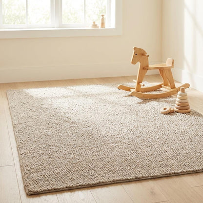 Handwoven chunky wool loop rug in neutral beige with thick, textured fibers for cozy minimalist Scandinavian home decor