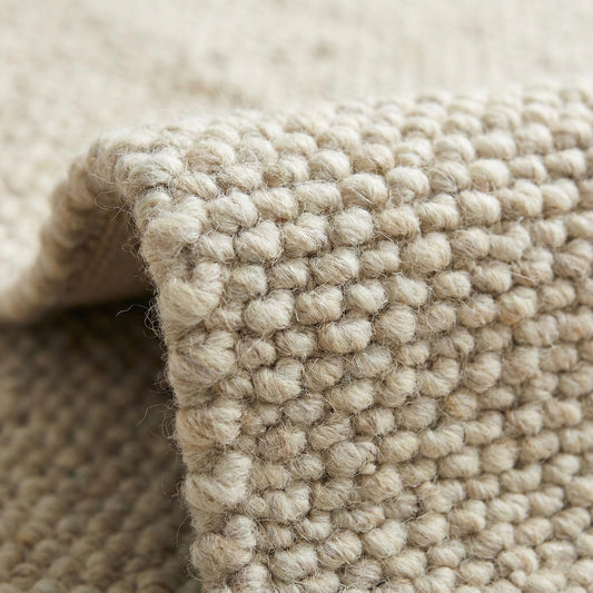Chunky wool neutral area rug with textured ivory woven loops for cozy modern interiors