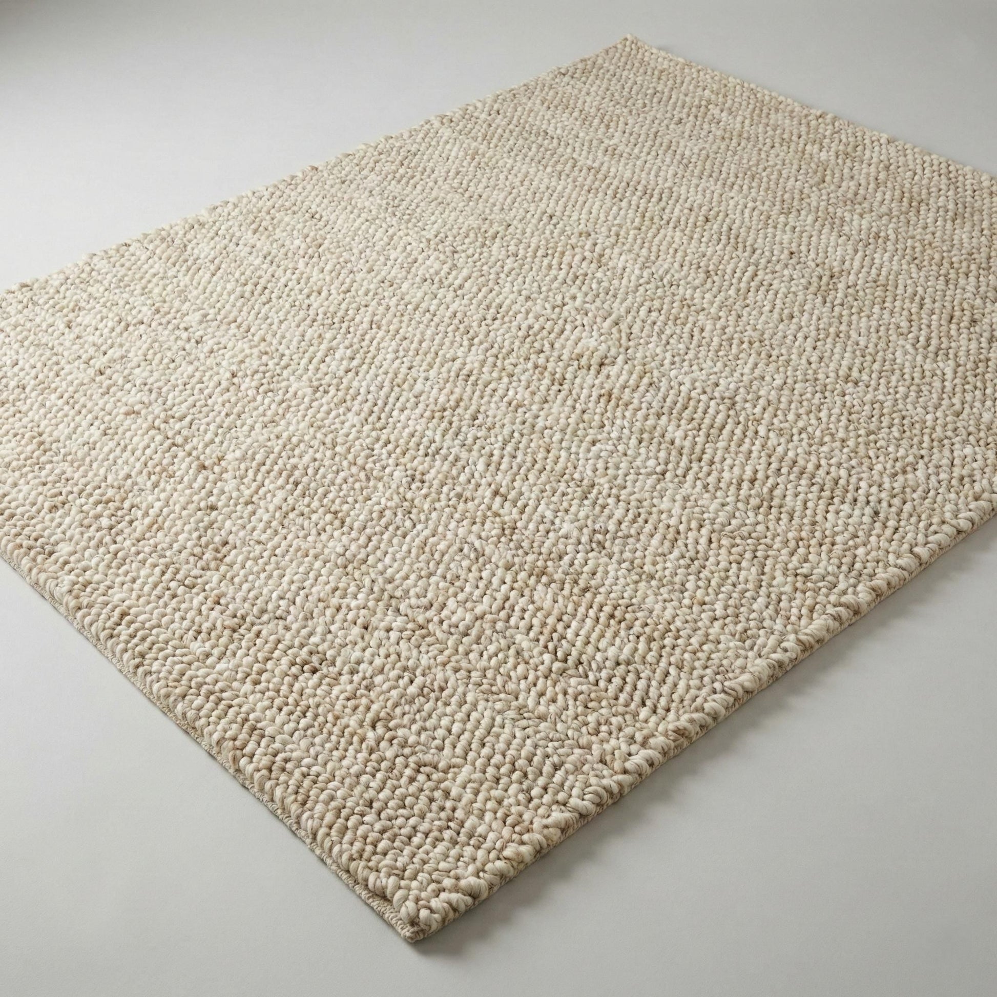 Chunky wool neutral area rug with thick textured cream loops for cozy modern interiors