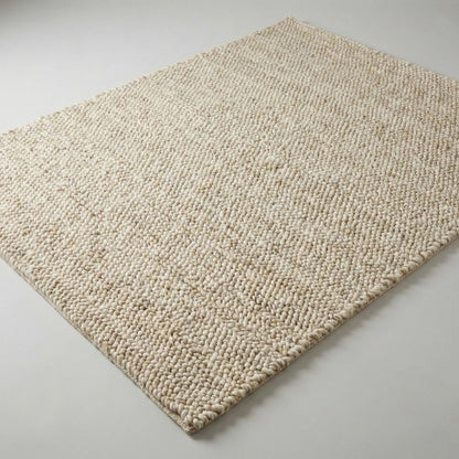 Chunky wool neutral area rug with thick textured cream loops for cozy modern interiors